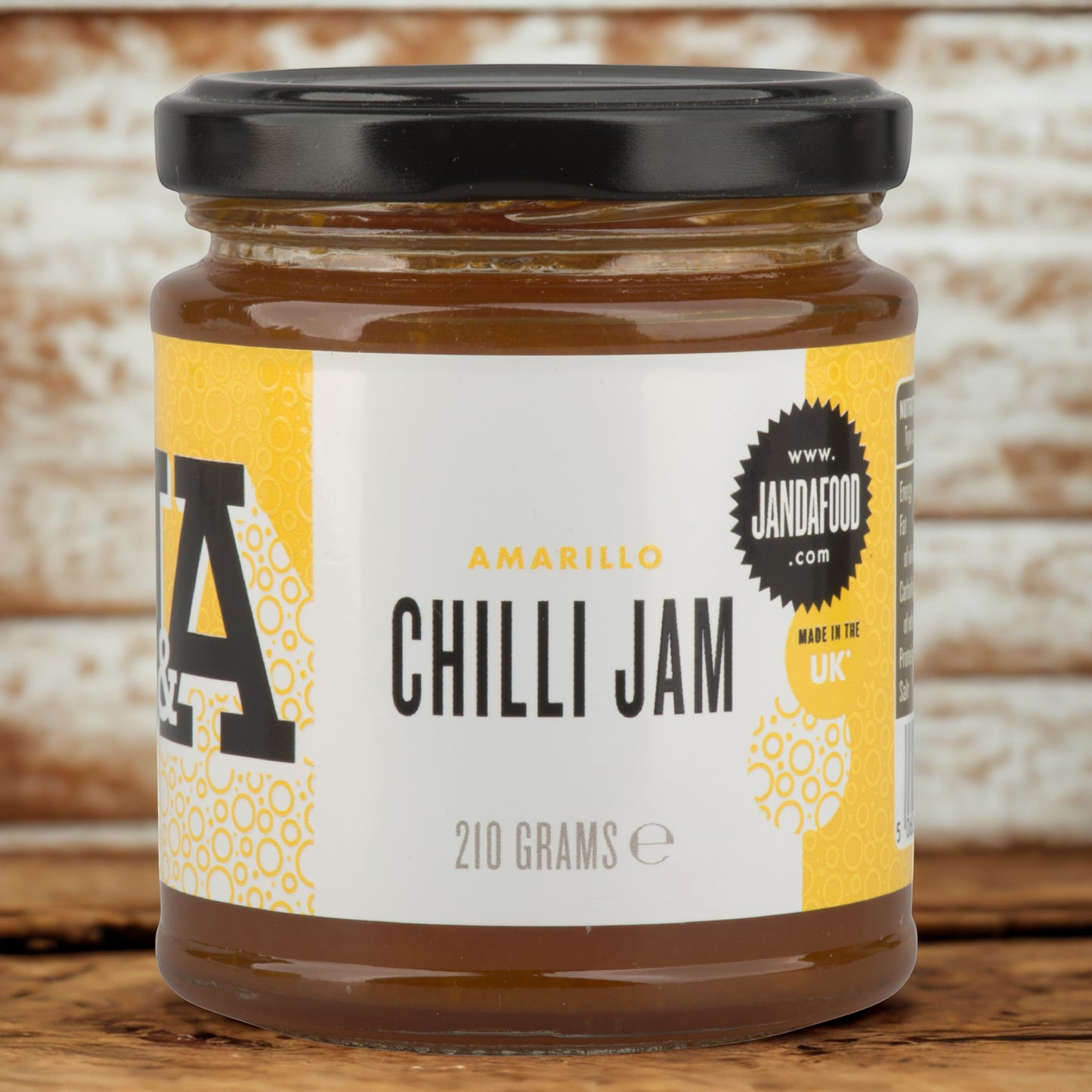 Janda Food Amarillo yellow chilli jam in a glass jar with a black lid, featuring a vibrant yellow and white label.