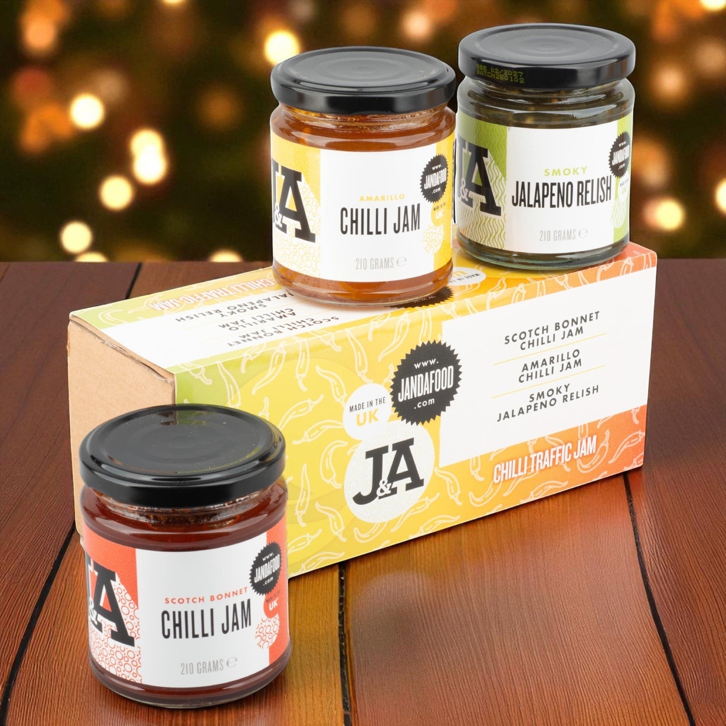 Janda Food Traffic Chilli Jam Gift Box featuring three jars of artisan chilli jams and relish on a wooden table