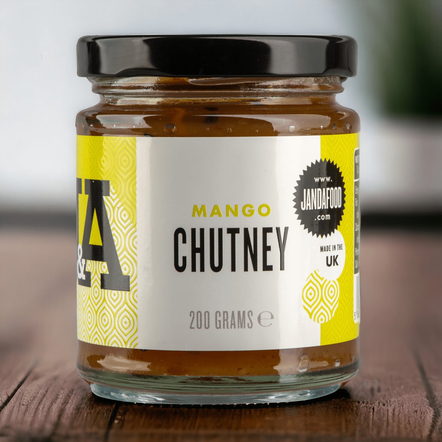 Janda Food Mango Chutney in a 200g glass jar with a black lid, featuring chunky mango pieces and delicate spices.