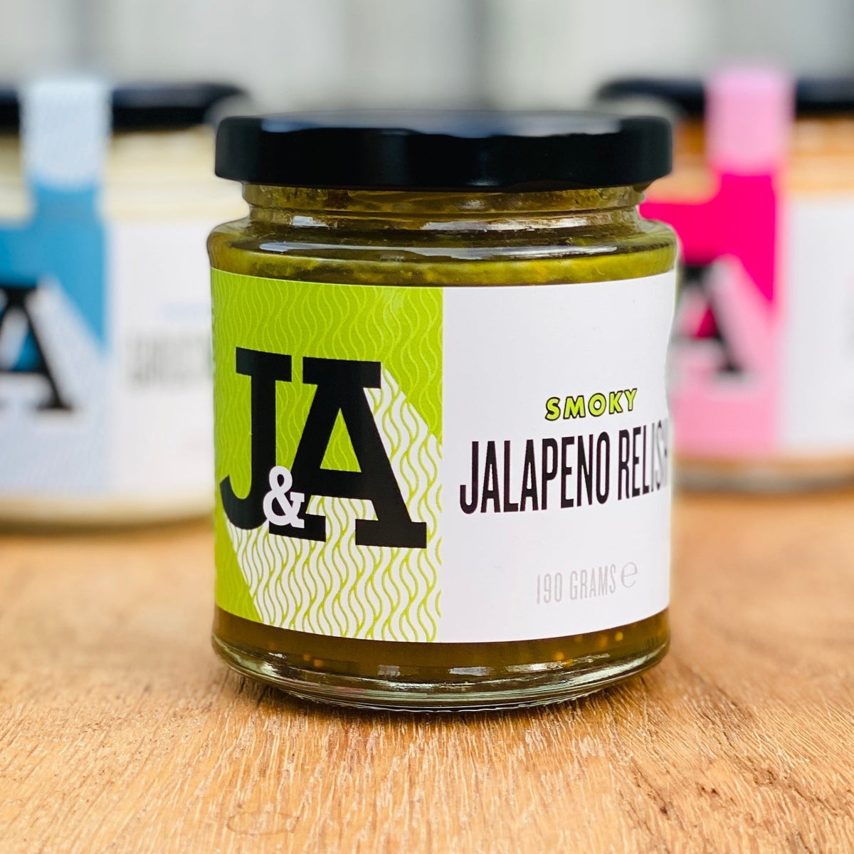 Janda Food Smoky Jalapeno Relish in a glass jar with a green label, featuring aged green jalapenos and smoky notes.