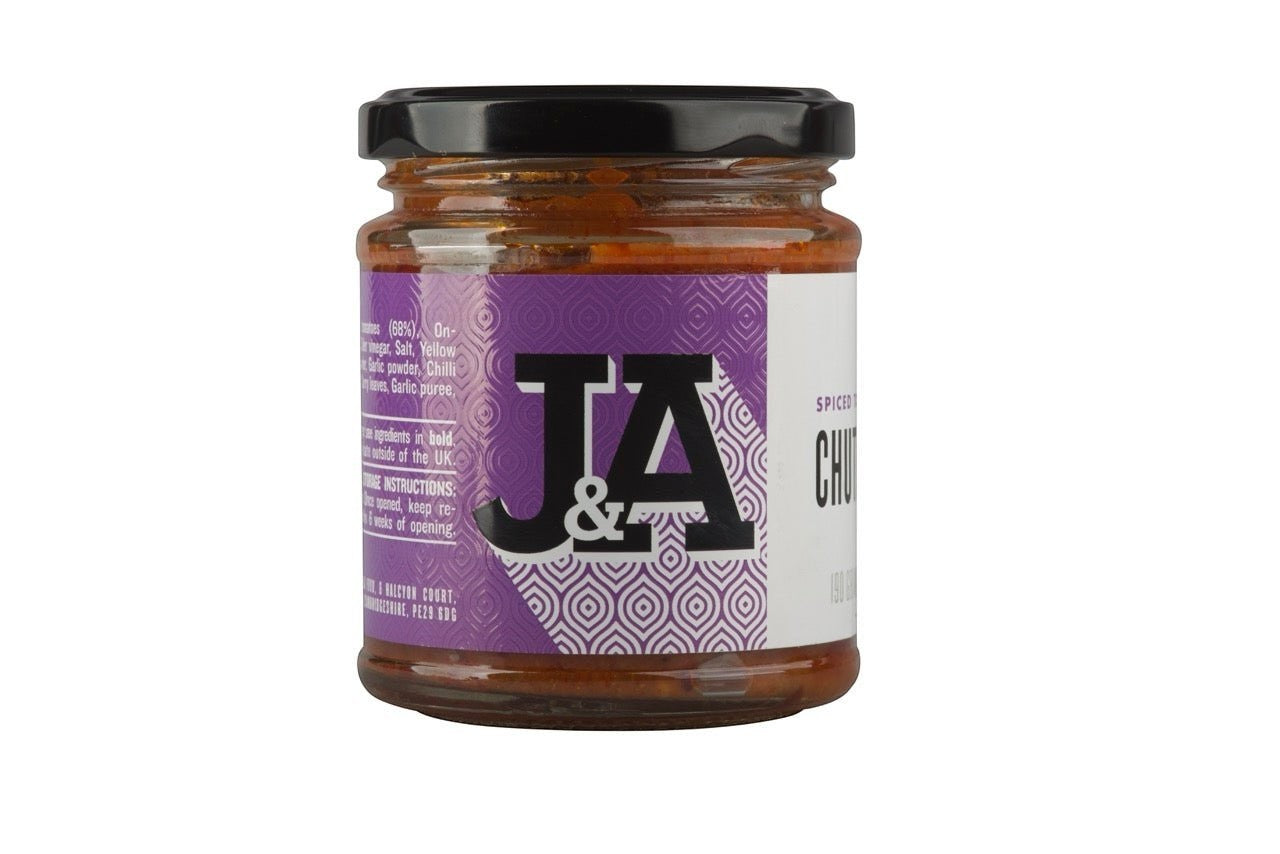 Janda Food spiced tomato chutney in a glass jar with a purple label featuring the J&A logo, made in small batches.