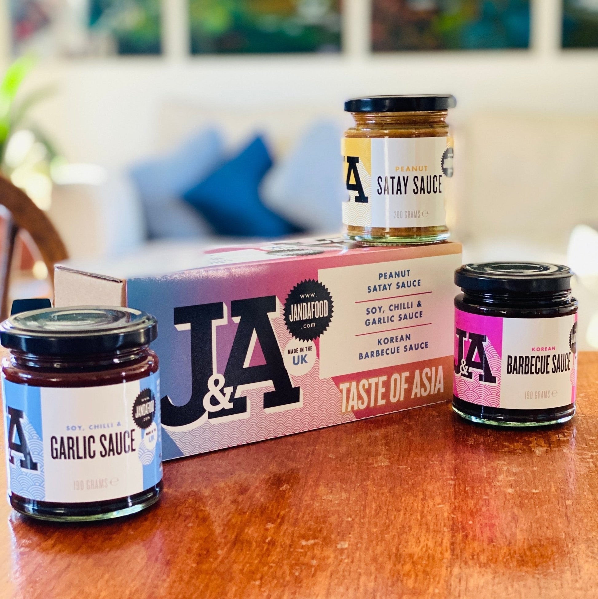 Janda Food Taste of Asia gift box featuring three glass jars of Korean Barbecue, Satay, and Soy Chilli Garlic sauces.