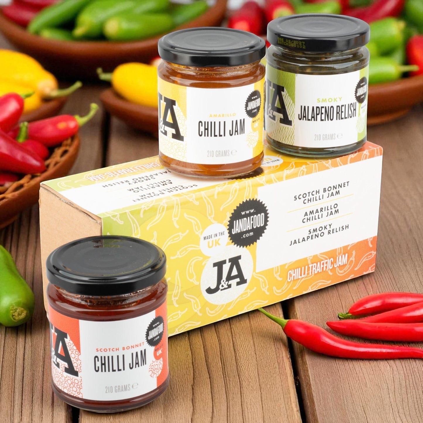 Janda Food Traffic Chilli Jam Gift Box featuring three jars of artisan chilli jam and relish on a wooden table.