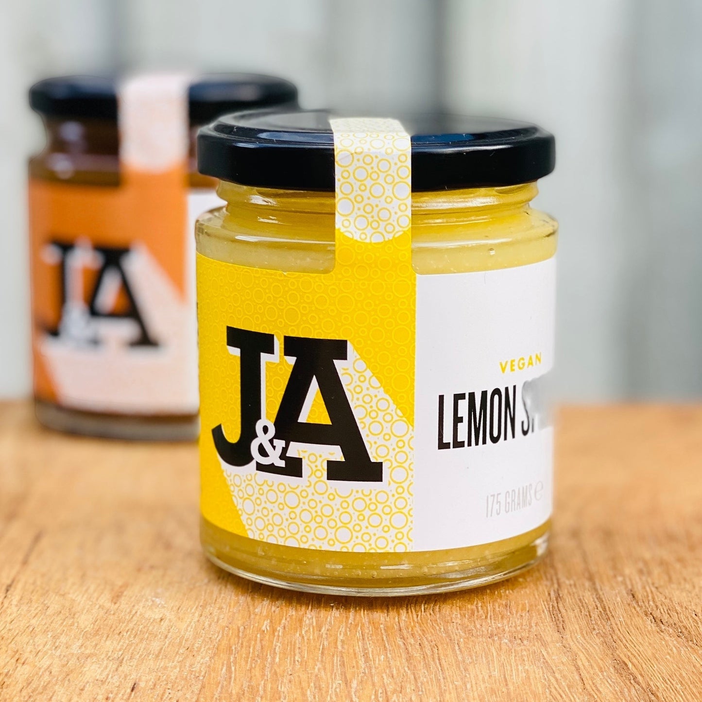 Janda Food vegan lemon curd in a glass jar with a yellow label, featuring a creamy texture and zesty citrus flavour.