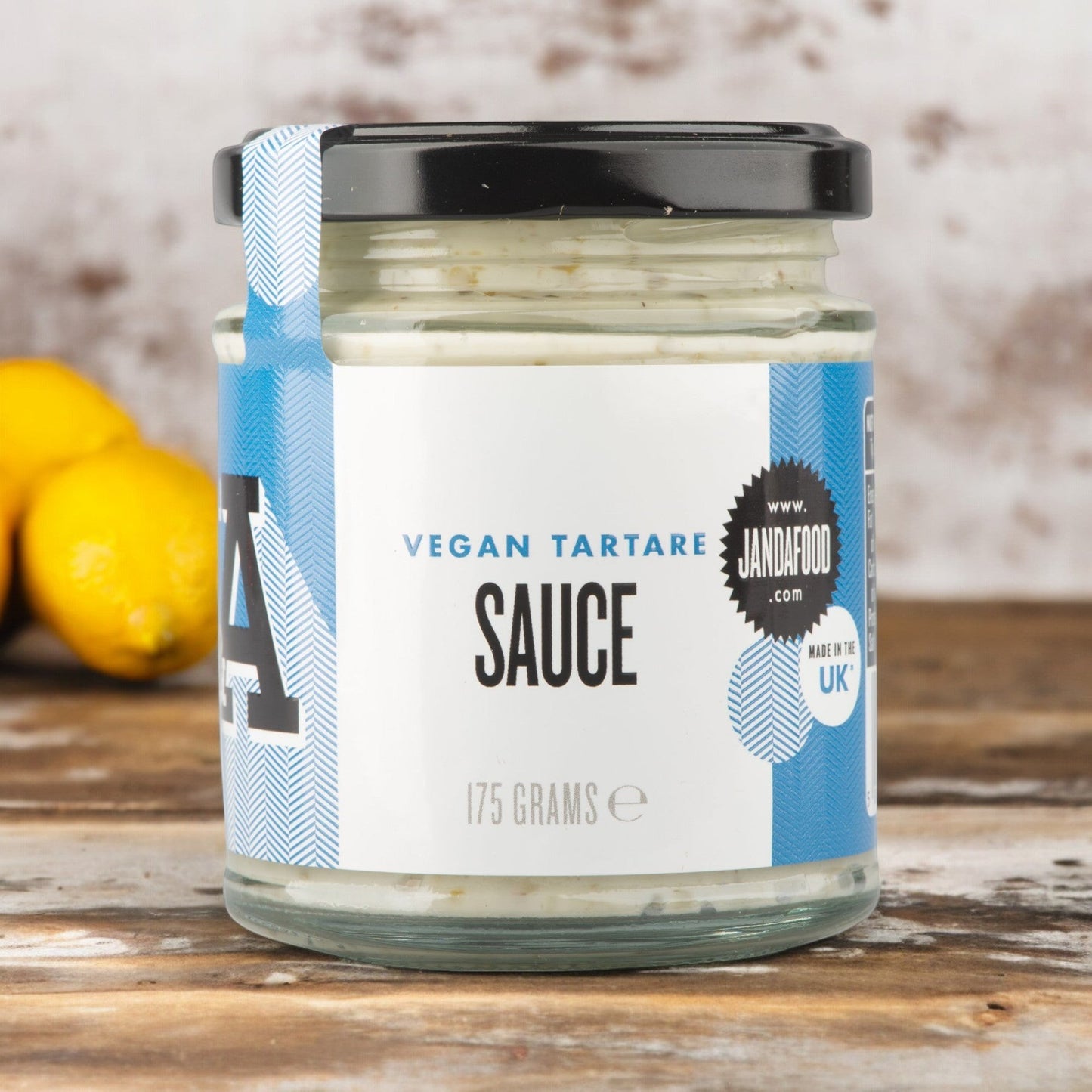 Janda Food vegan tartare sauce in a glass jar with blue label, featuring gherkins, lemon, and capers.